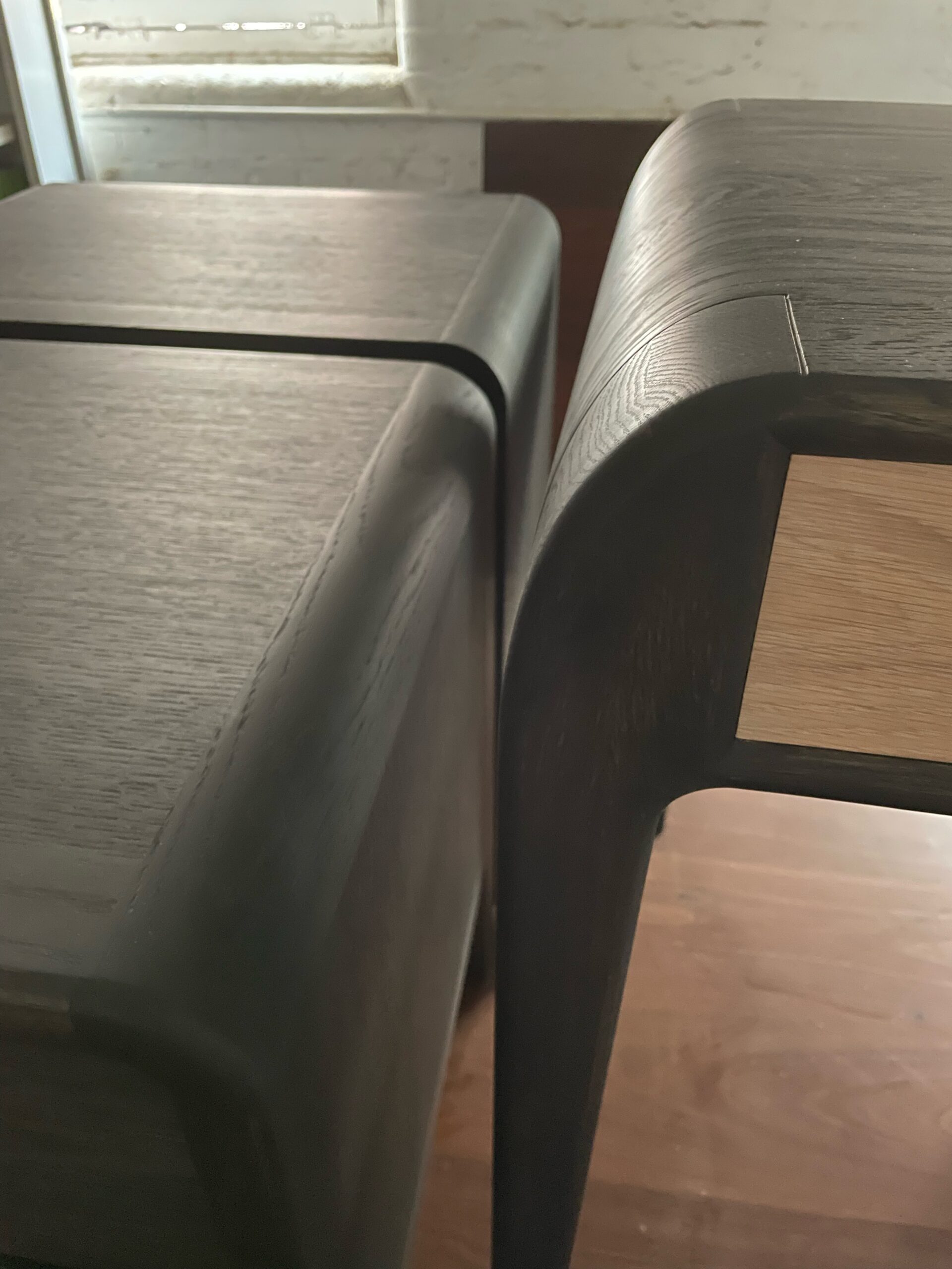 Curved corner detail - Ebonised oak bedside tables and desk for penthouse suite.